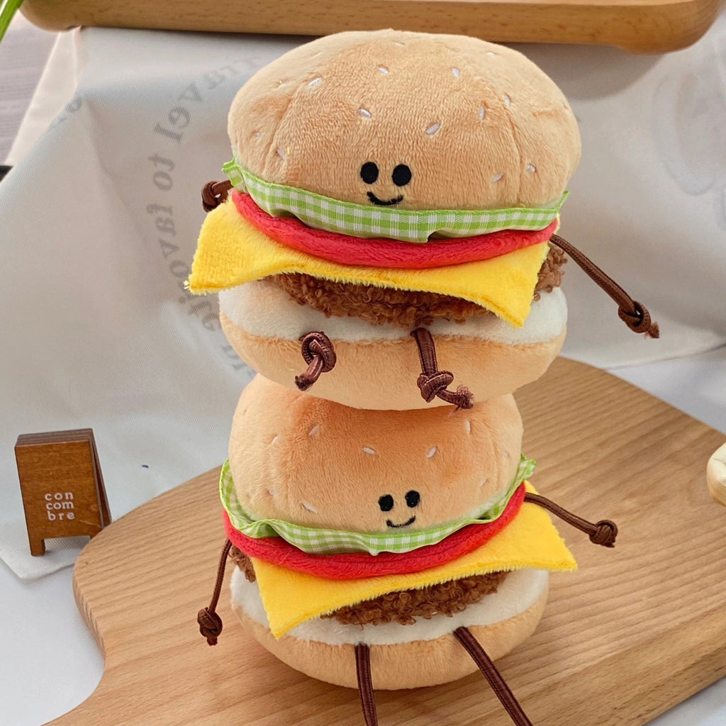 Plush burger toy clipped to backpack