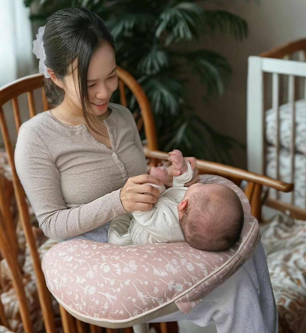 Mum and baby supported during feeding with nursing pillow