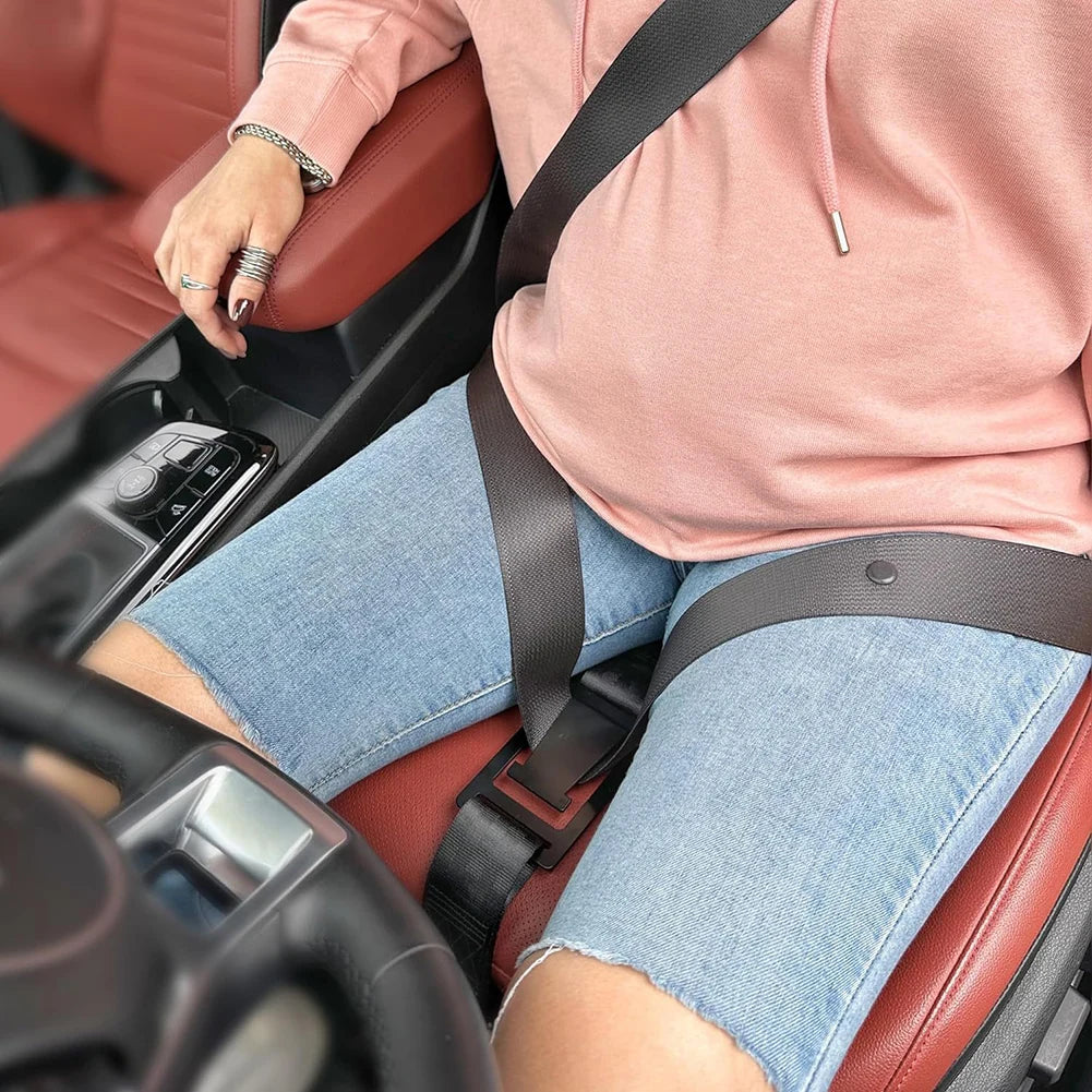 Pregnant woman using car seat belt adjuster