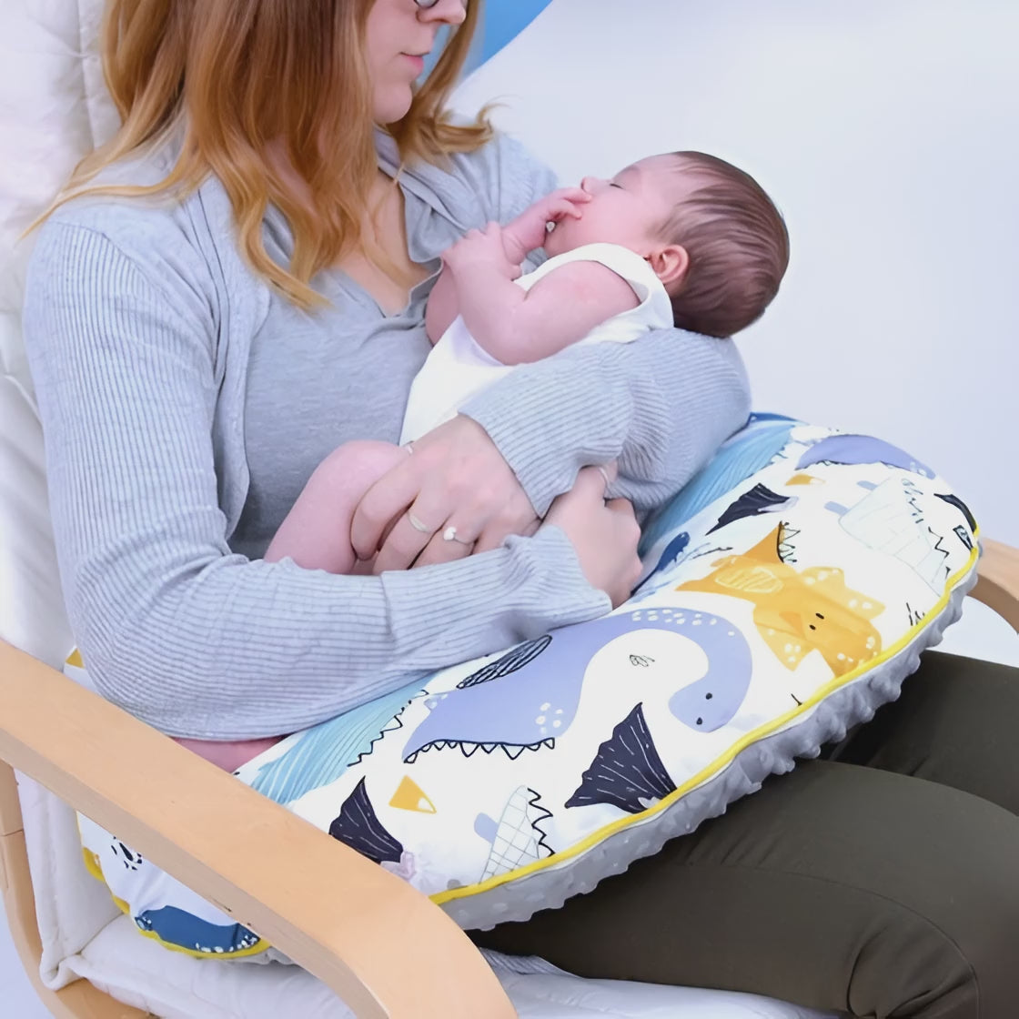 Mom using nursing pillow for breastfeeding support